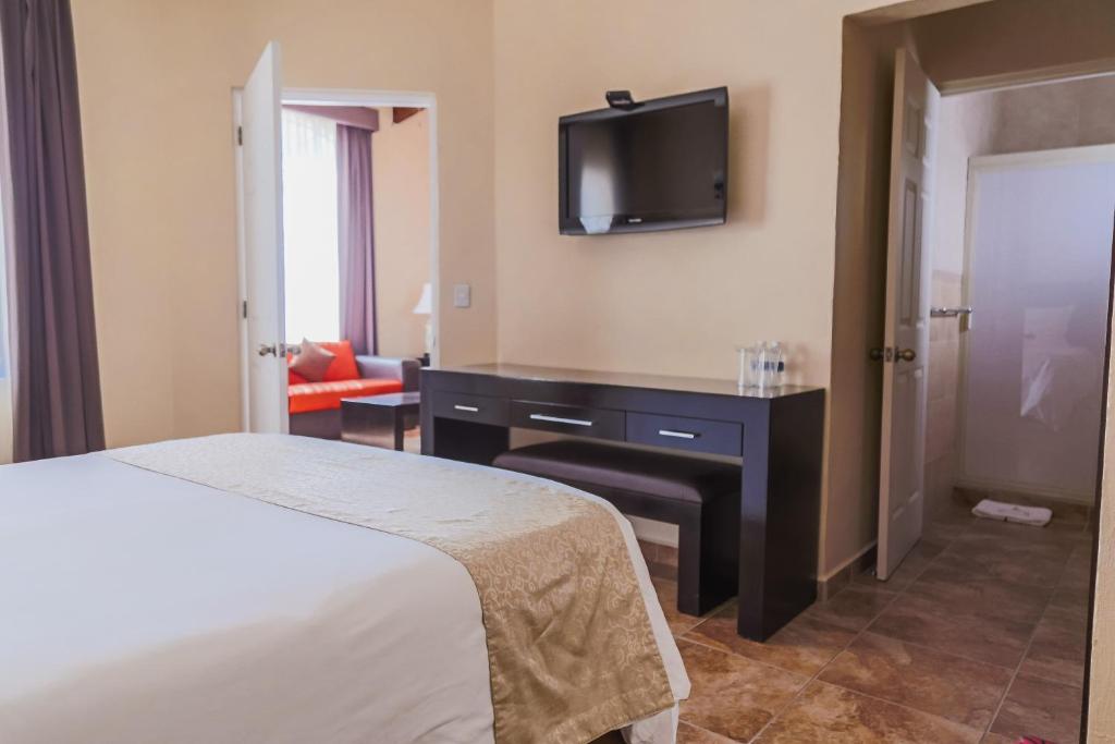 Postel nebo postele na pokoji v ubytování Hotel Real de San Jose