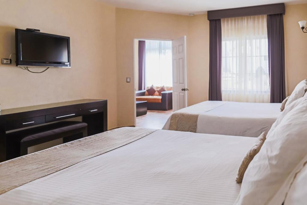 Postel nebo postele na pokoji v ubytování Hotel Real de San Jose