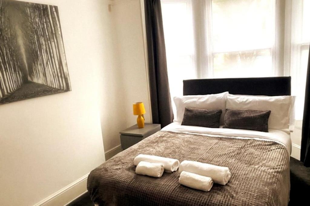 a bedroom with a bed with two towels on it at Gravesend - 1 bedroom Apartment in Kent