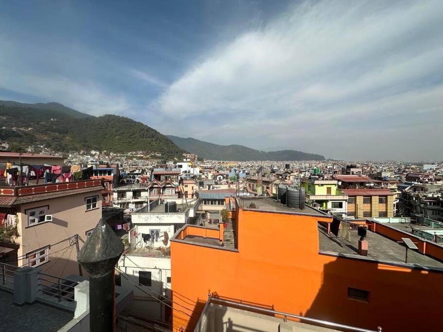 a view of a city with buildings and mountains at Monkey Temple Apartment in Kathmandu