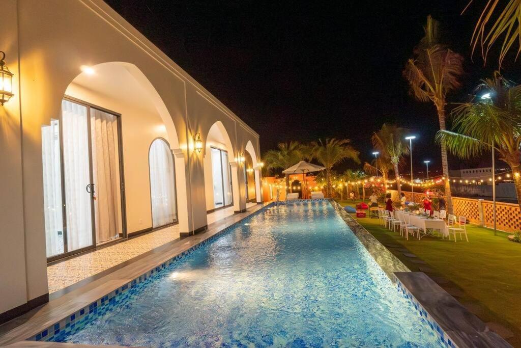 a swimming pool in a house at night at Amanda villa 4 Phan Thiết in Mui Ne