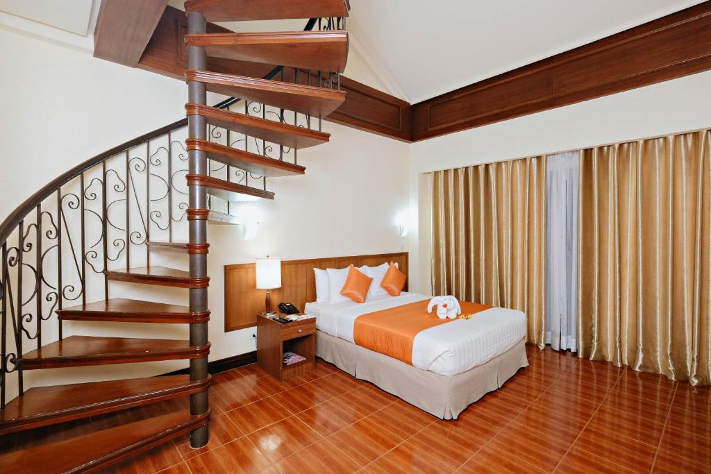 Postel nebo postele na pokoji v ubytování The Suites At Mount Malarayat