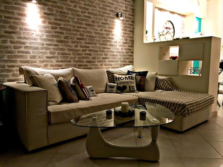 a living room with a couch and a glass table at Home Sweet Home! in Volos