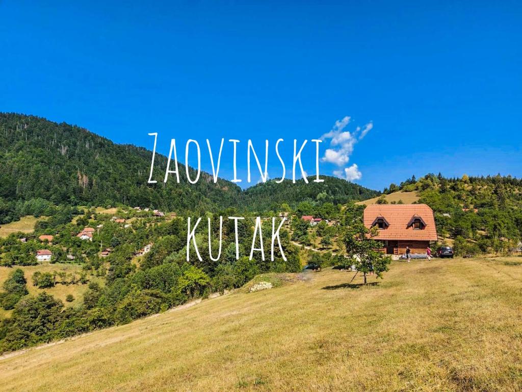 a house on a hill with a sign that reads knowing kulture at Zaovinski kutak in Bajina Bašta