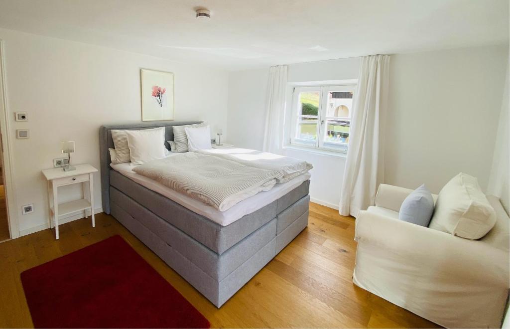 ein Schlafzimmer mit einem großen Bett und einem Sofa in der Unterkunft Landhaus Constantin Luxus-Appartments in Berchtesgaden