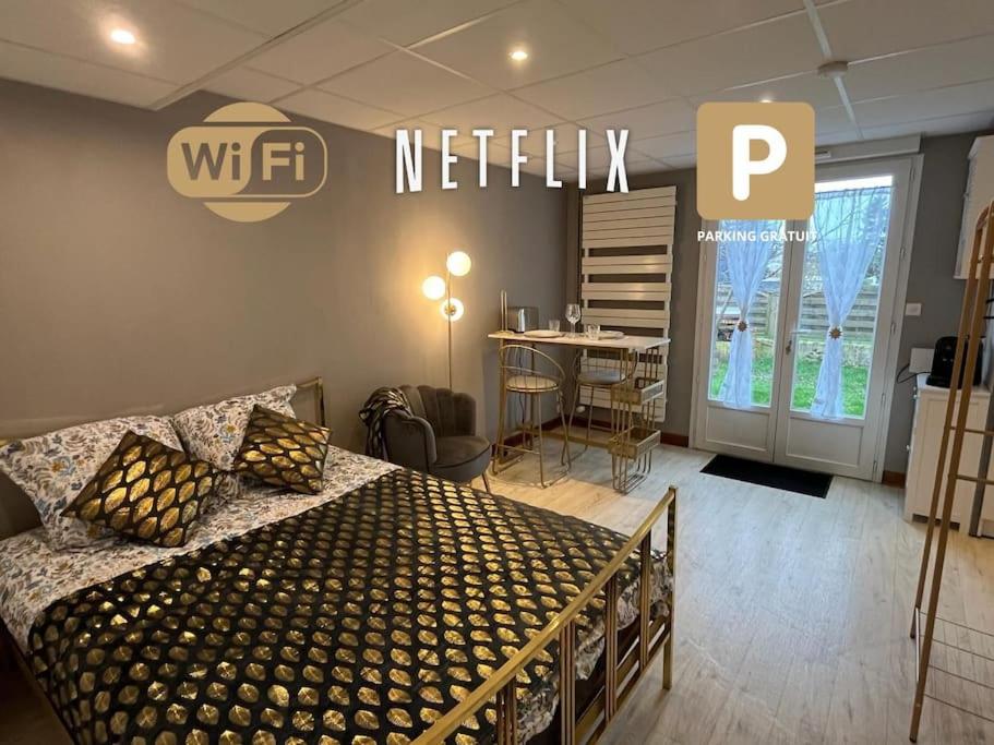 a bedroom with a bed and a netflix sign on the wall at Golden Tours - Studio moderne in Tours
