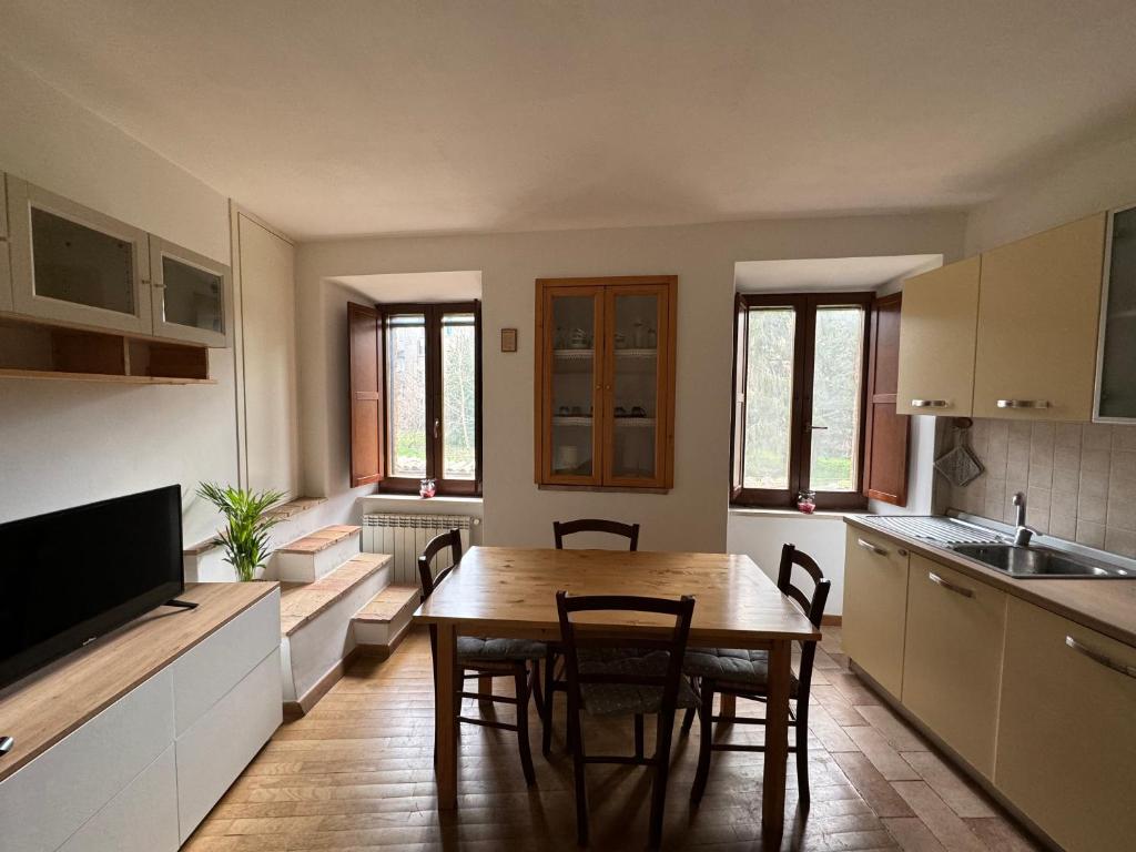 a kitchen with a wooden table and chairs in it at Casa Vacanze Mary in Orvieto