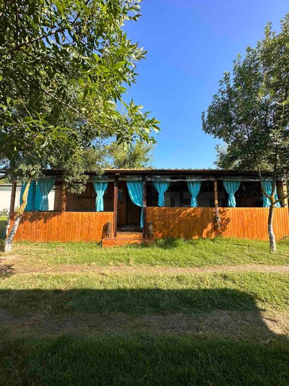 a house with a fence and trees in front of it at Oasis Blue Lozenets in Lozenets
