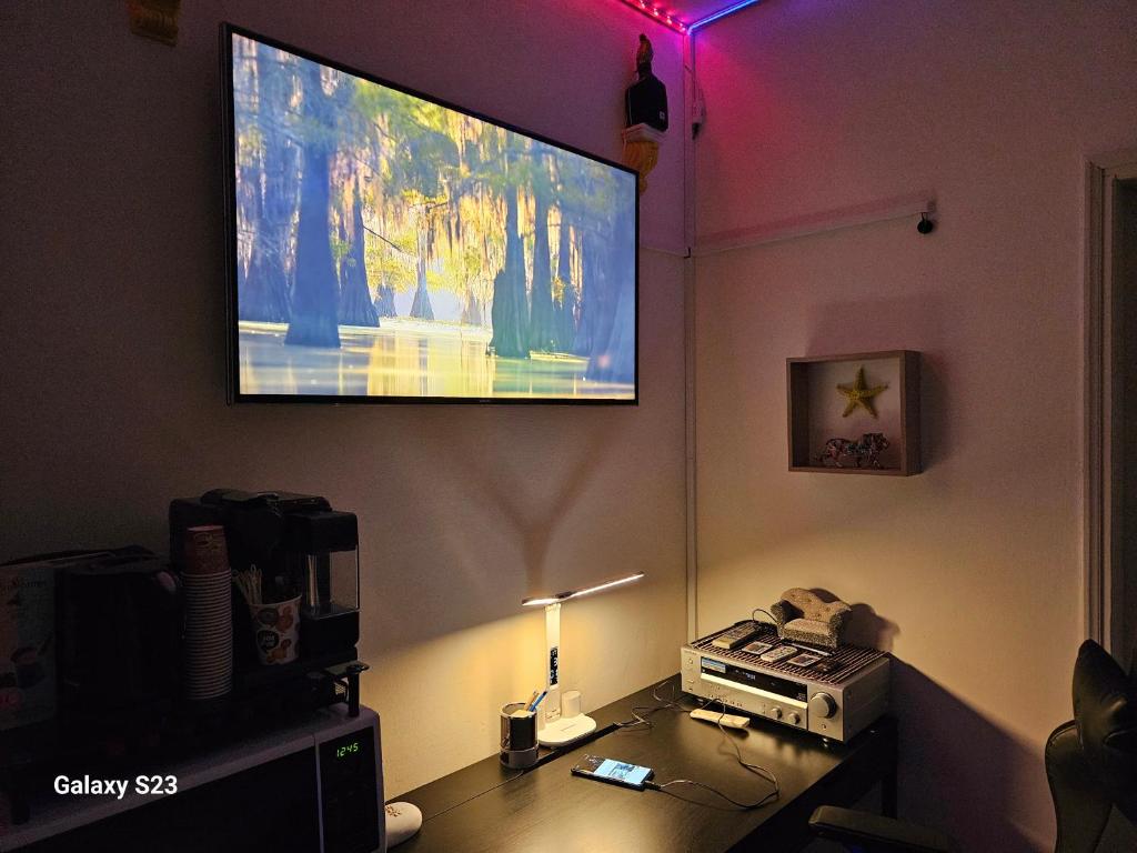 a living room with a flat screen tv on the wall at Cool place in Ramat Gan in Ramat Gan