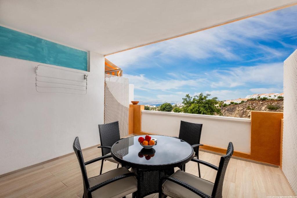 a dining room with a table and chairs and a large window at Ocean View Apartment with large terrace and Netflix smart TV Costa Adeje in Adeje