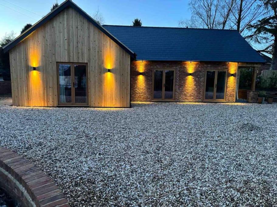 a house with a gravel yard in front of it at Highfield in Rous Lench