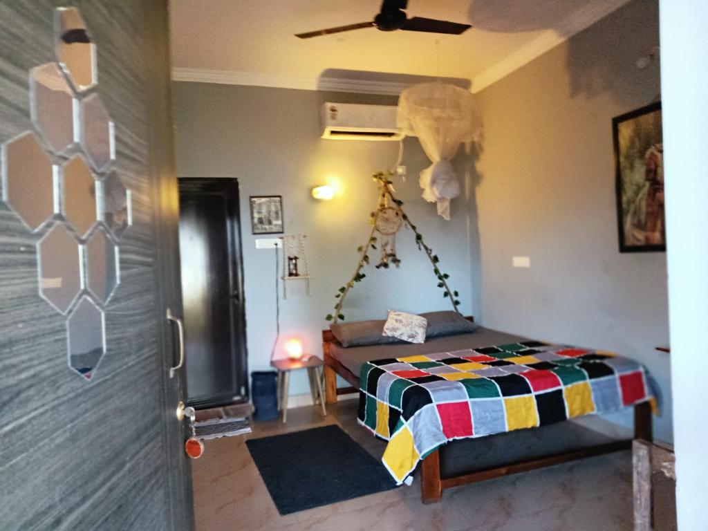 a bedroom with a bed in a room at The Caveman Goa-River-view Retreat. in Arambol