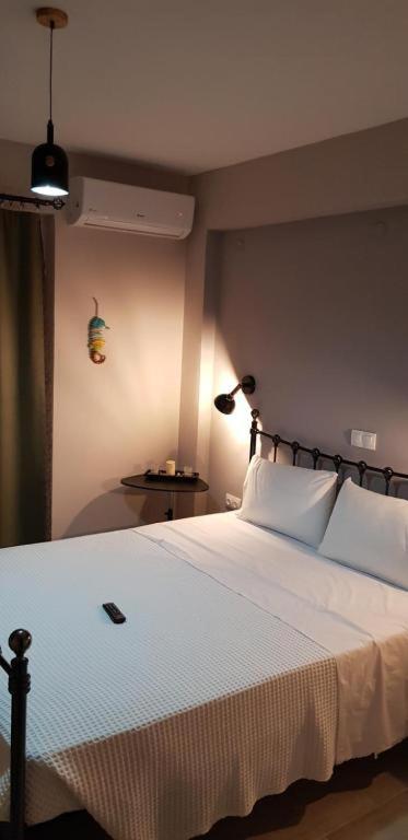 a bedroom with a large white bed with two lamps at Villanta 2 in Kallirákhi