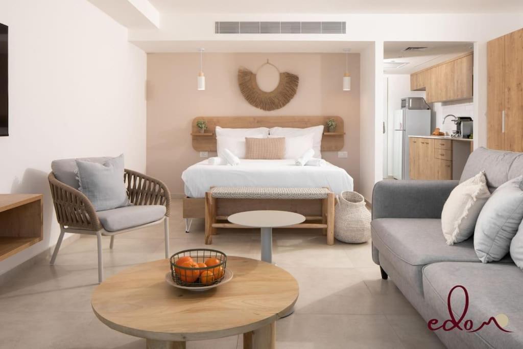 a living room with a bed and a couch at סוויטה משפחתית ליד הים - By Edomlux in Eilat