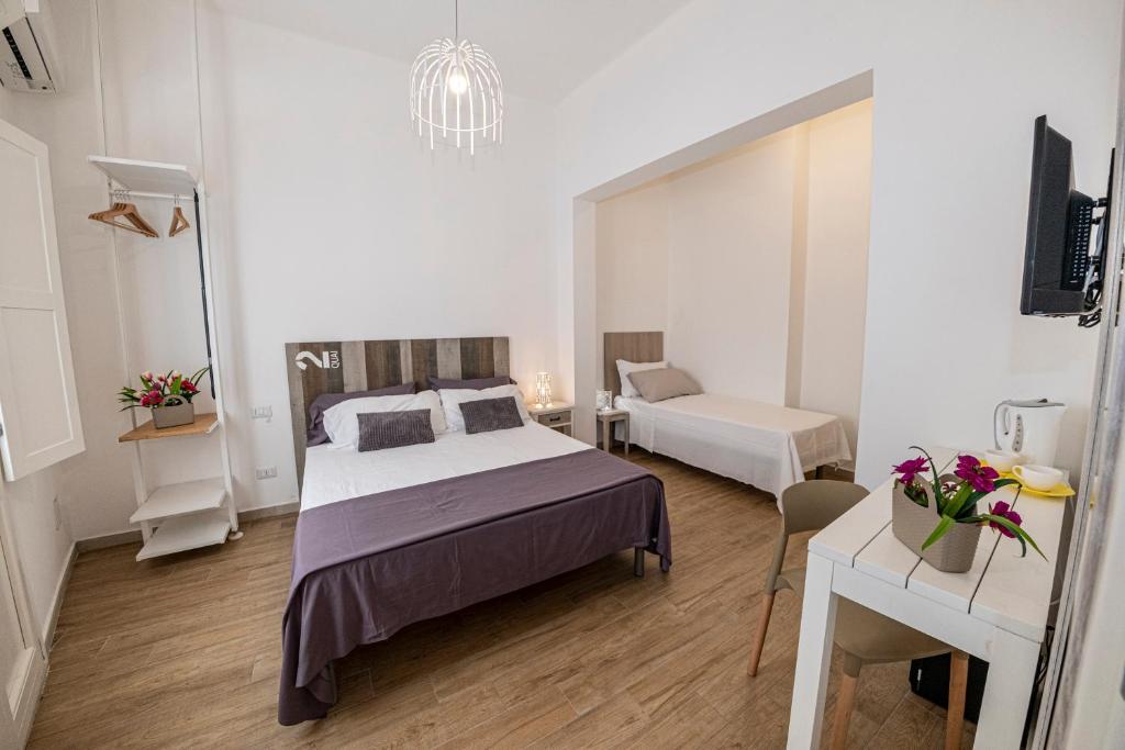 Postel nebo postele na pokoji v ubytování B&B - Le Tre Comari