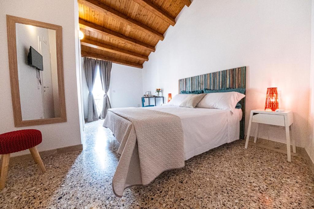 Postel nebo postele na pokoji v ubytování B&B - Le Tre Comari