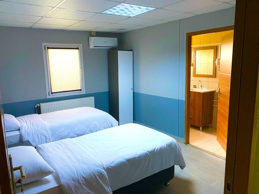 a hospital room with two beds and a sink at MARİNO HOTEL in Gulyali