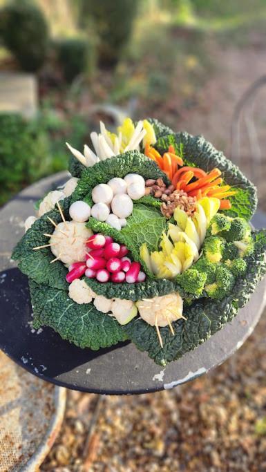 a plate of vegetables on top of a table at Gîtes du Manoir de la Porte in Les Authieux-sur-Calonne