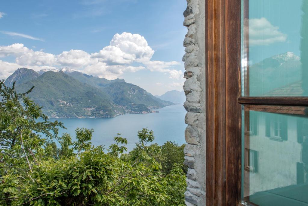 a view of a lake from a window at Casa San Martino Lago Di Como in San Siro