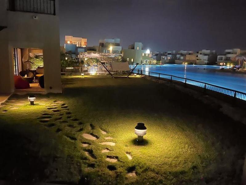 a night view of a yard with footprints in the grass at Marassi Blanca in El Alamein