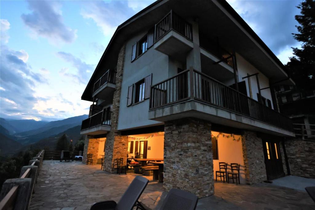 a house with a balcony on a mountain at La Misun de Ciafrè in Casteldelfino
