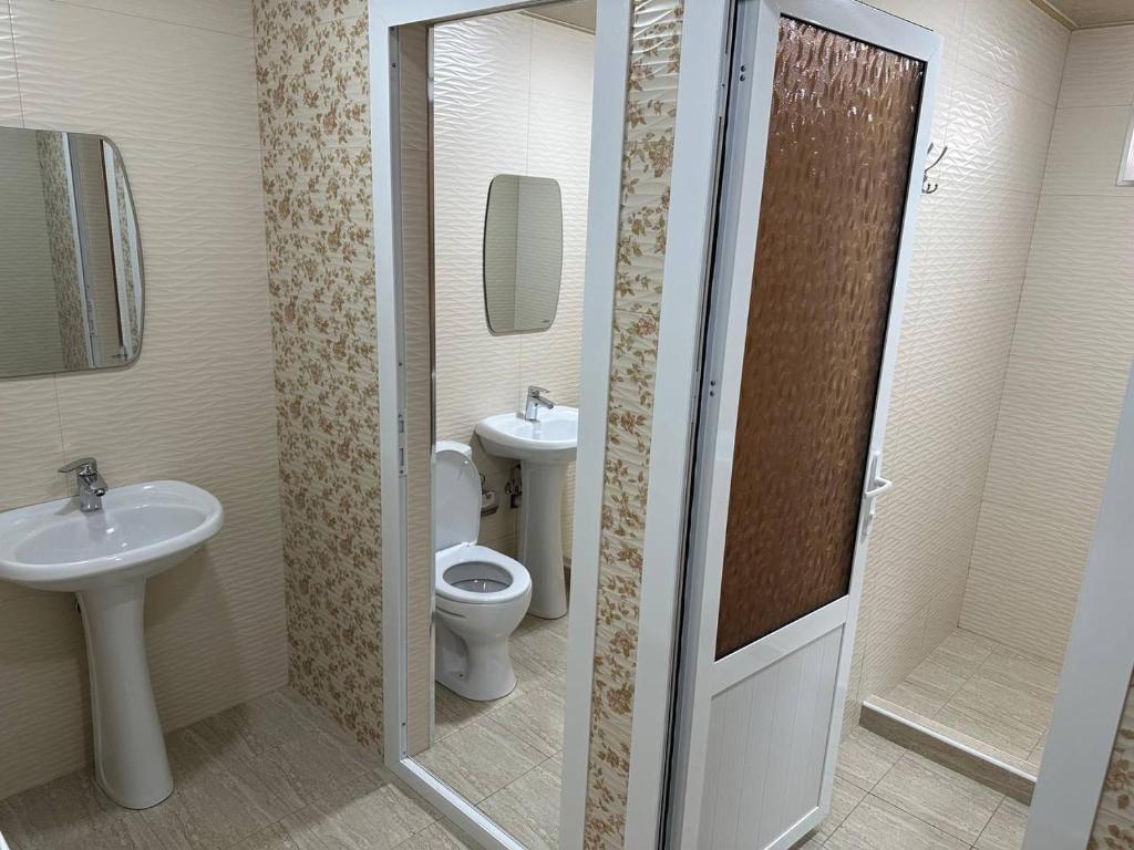 a bathroom with a toilet and a sink at Хостел Мистер Шох in Koshbakaly