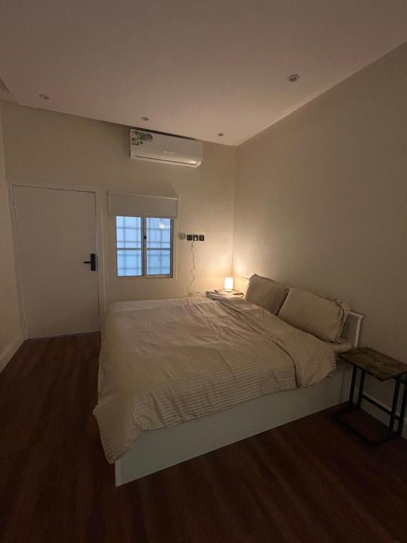 a bedroom with a white bed and a window at Secret Garden Studio استوديو بمدخل جانبي خاص ودخول ذكي in Riyadh