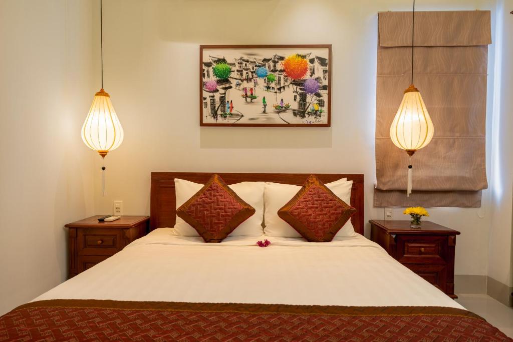 Postel nebo postele na pokoji v ubytování Iris De Villa Hoi An