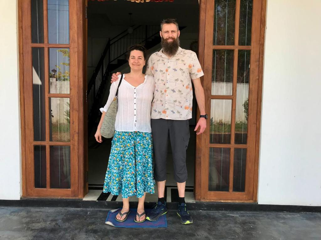 a man and a woman standing in front of a door at Yapahuwa Oasis in Maho