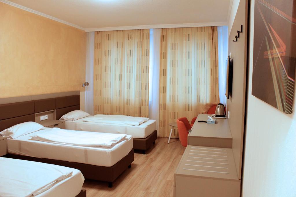 Postel nebo postele na pokoji v ubytování Isar City Hotel