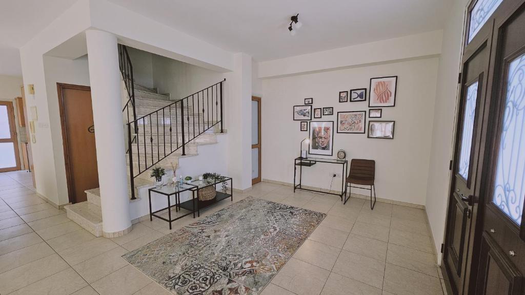 a living room with a staircase and a rug at STAY Tranquility Cove in Larnaca