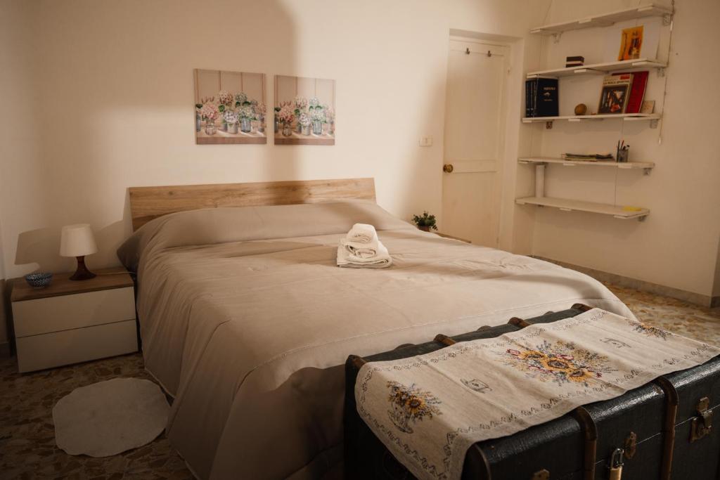 a bedroom with a bed with two towels on it at TWO-ROOM Apt. under the Aqueduct's ARCH in Pigneto in Rome