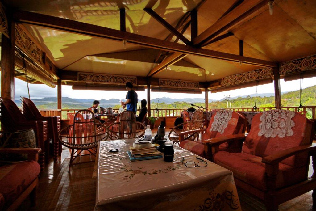 a restaurant with a table and chairs with a view at Labang Guesthouse Bario in Bario