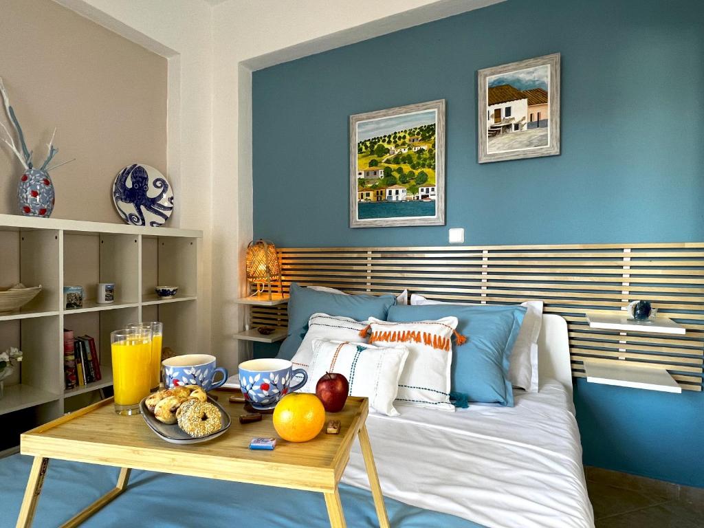 a bedroom with a bed with a table with fruit on it at Casa Portokali Chalkidiki in Nea Potidaea