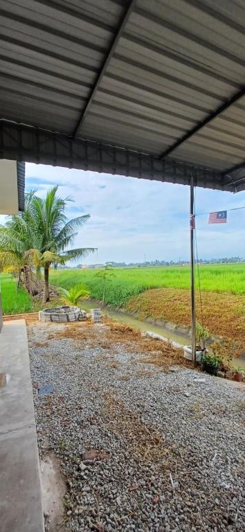 a view of a field from under a building at Inap Hujung kampung in Penaga