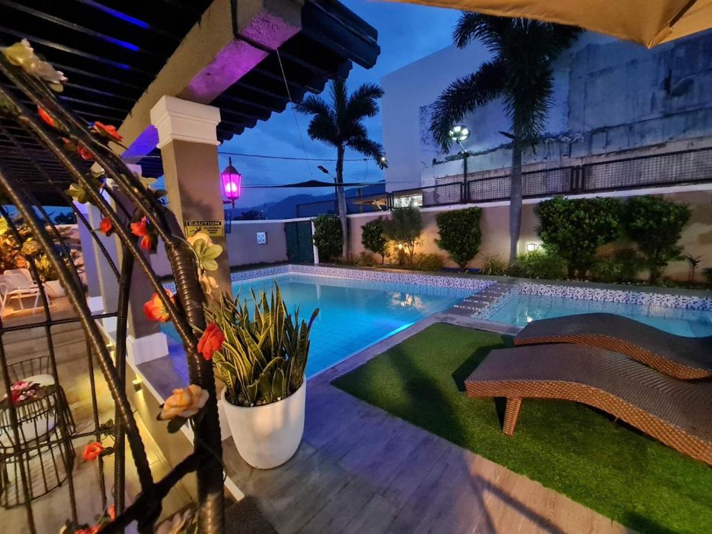 a swimming pool in a backyard at night at Palazzo 1 HotSpring,3Bedrooms 35to40pax, Pansol Calamba in Pansol