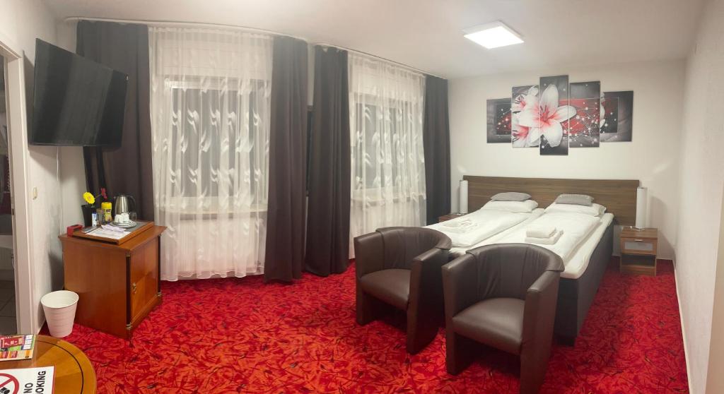 Postel nebo postele na pokoji v ubytování Hotel Am Wildpark