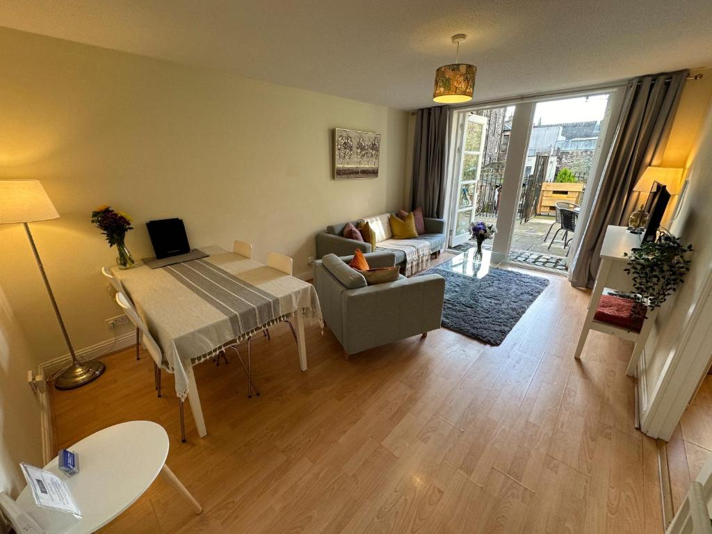 a living room with a table and a couch at Castle Wynd Old Town in Edinburgh