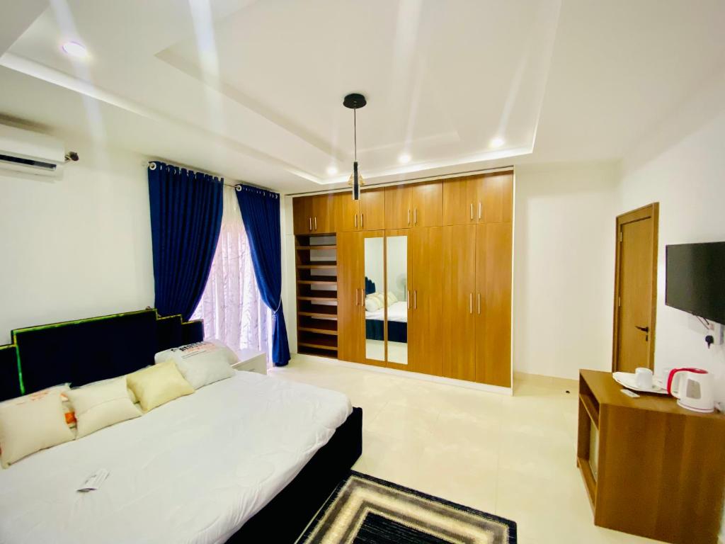 a bedroom with a large bed and a television at Abuja Getaways in Abuja