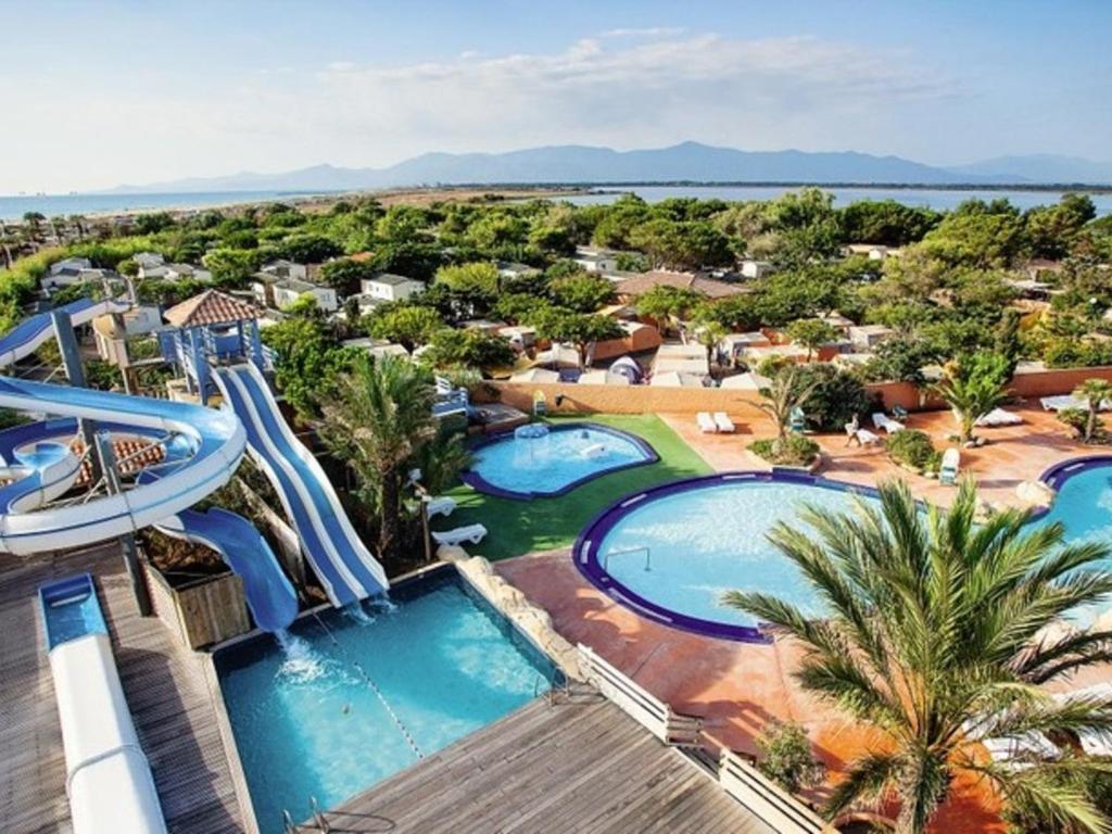an aerial view of a resort with two pools at SOLEIL & PLAGE au CAMPING MAR ESTANG 4 ETOILES in Canet-en-Roussillon