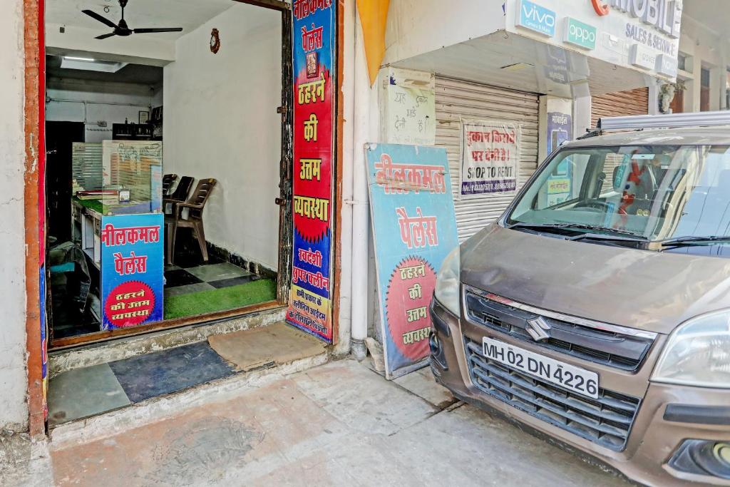 a car parked in front of a garage at OYO Hotel Neelkamal palace and Guest house in Nāthdwāra