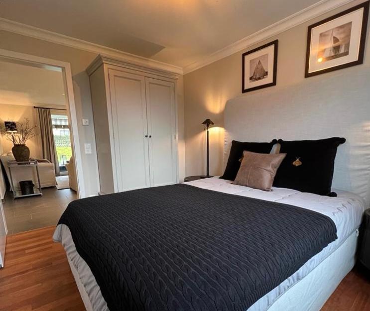 a bedroom with a large bed with a black comforter at Appartement ALLURE Wohnen auf Zeit in Eschen