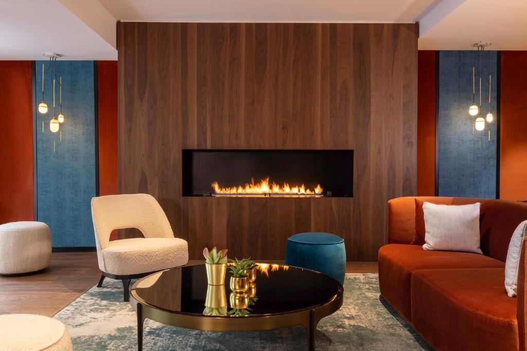 a living room with a couch and a fireplace at Hotel Villa Maillot in Paris