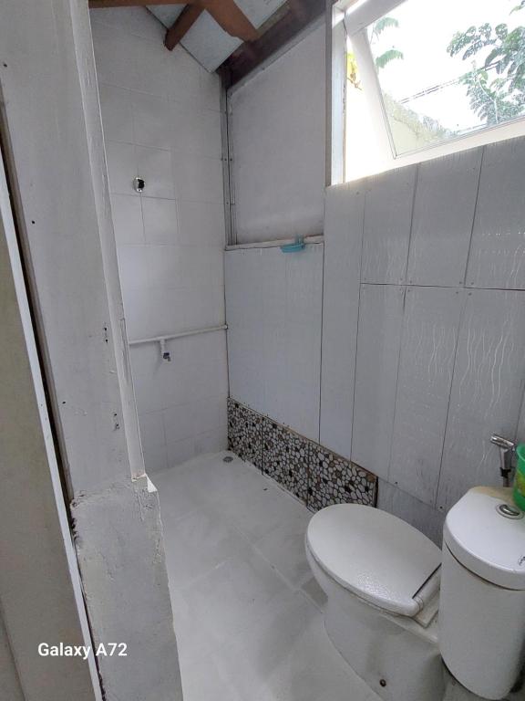 a bathroom with a toilet and a shower with a window at My Guest House She 