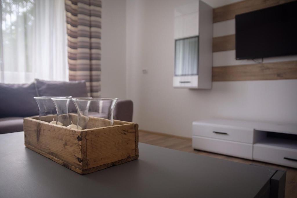 a wooden box sitting on a table in a living room at Kincses Vendégház in Senta