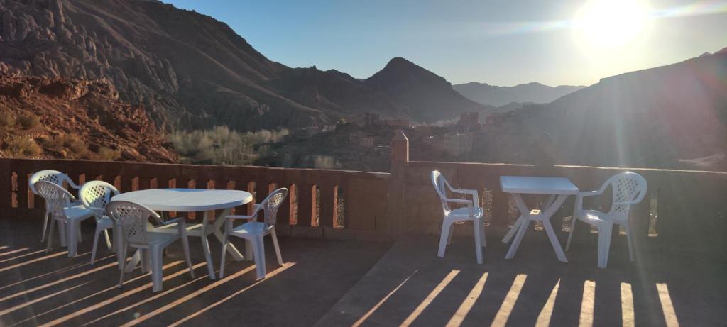 a table and chairs on a balcony with a view at Gorges View Dades in Tamellalt