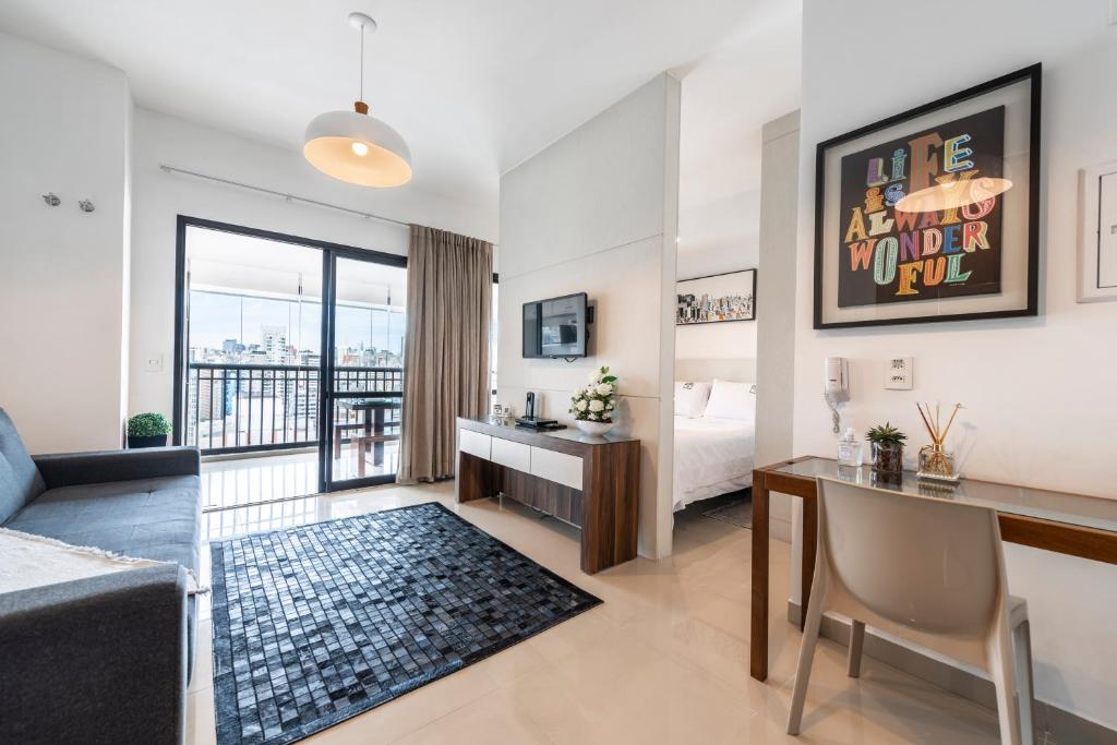 a hotel room with a bed and a desk and a desk at Rosemari's Apartments SJ Urban Chic in Sao Paulo