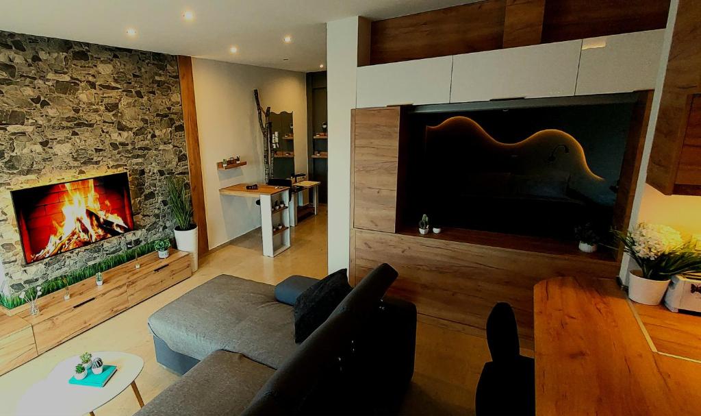 a living room with a couch and a fireplace at Sky view suite serres in Serres
