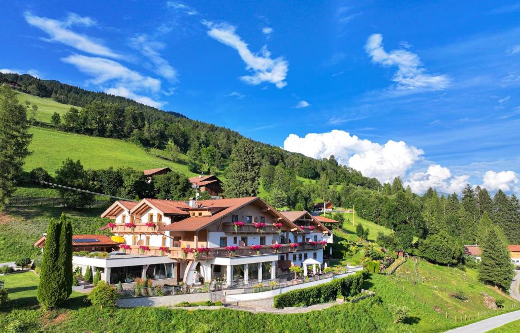 a large building on a hill in the mountains at Residence Garni Melcherhof in Racines