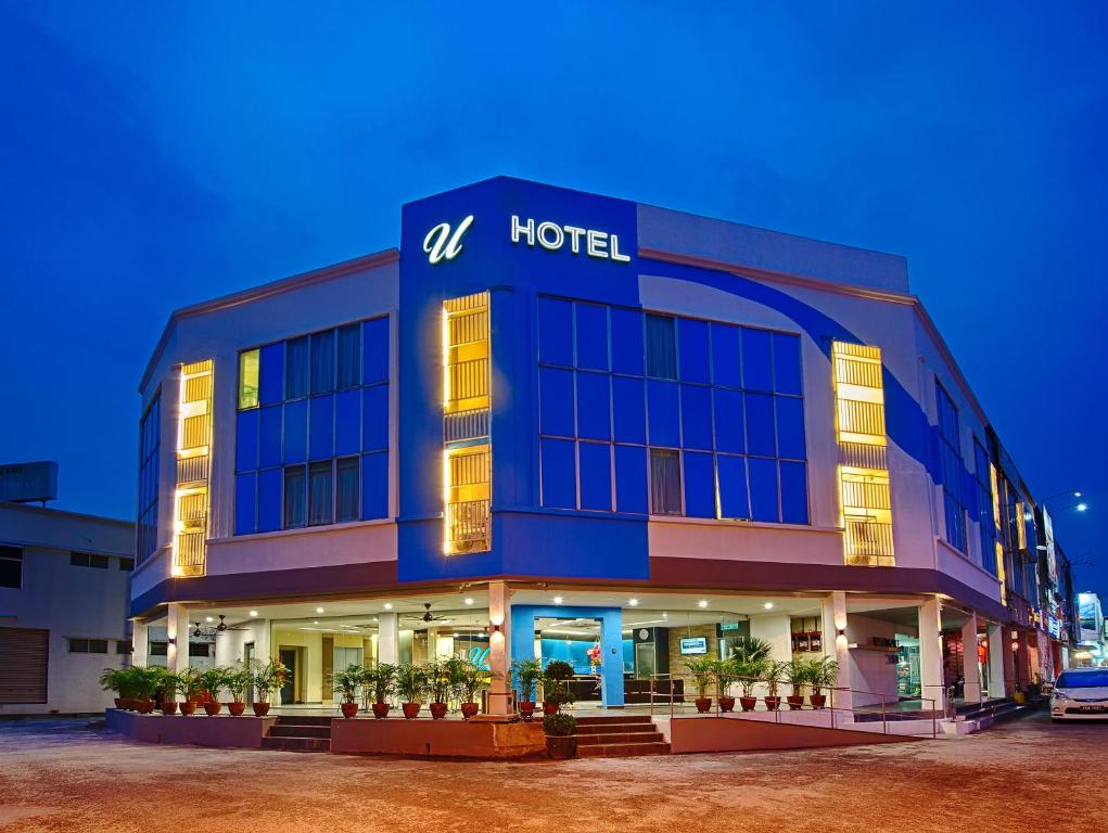 ブキッ・ムルタジャムにあるU Design Hotel Bukit Mertajamの表面に看板が出たホテルの建物